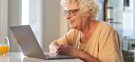 photo of an older woman using a laptop